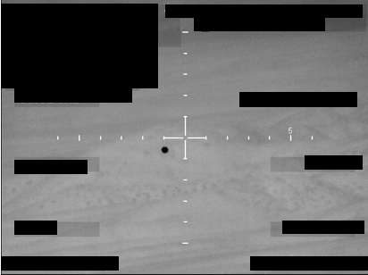 A monochrome image with a central crosshair reticle and a dark circular object, released by the FBI to the Pentagon's UAP office.